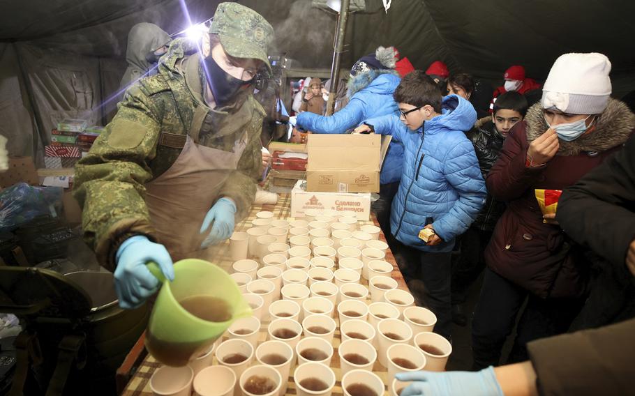 Migrants lineup to get meal and hot drinks inside a tent near a logistics center at the checkpoint “Kuznitsa” at the Belarus-Poland border near Grodno, Belarus, Tuesday, Nov. 23, 2021. Belarusian authorities say they have helped more than 100 migrants leave the country on Monday and more are prepared to leave Tuesday, a statement that comes after almost two weeks tensions at on the Belarus’ border with Poland, where hundreds of migrants remain stuck.