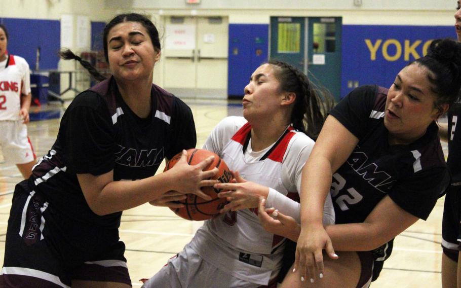 Zama's Kierstyn Aumua and Deborah McClendon sandwich E.J. King's Maliwan Schinker and the ball.