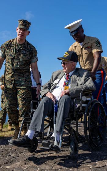 Marines, including Sgt. Maj. of the Marine Corps Troy Black, left, escort a Battle of Iwo Jima veteran during the Reunion of Honor ceremony March 25, 2023, at Iwo Jima, Japan. 