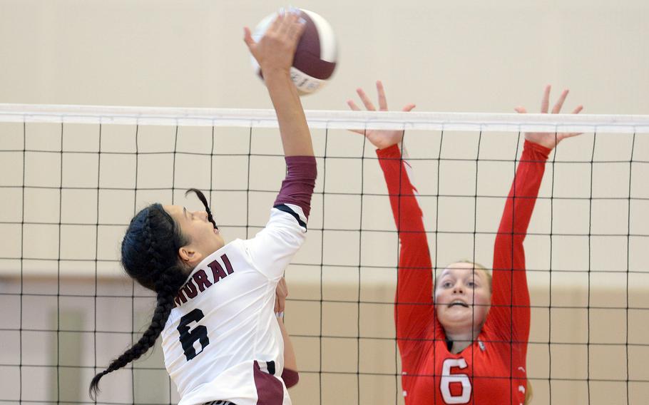 Matthew C. Perry's Chelsea Campbell hits the ball against E.J. King's Madylyn O'Neill during Saturday's DODEA-Japan volleyball match. The Cobras won 25-10, 25-15, 25-13, hours after also beating the Samurai 25-7, 25-10, 25-7 on Friday.