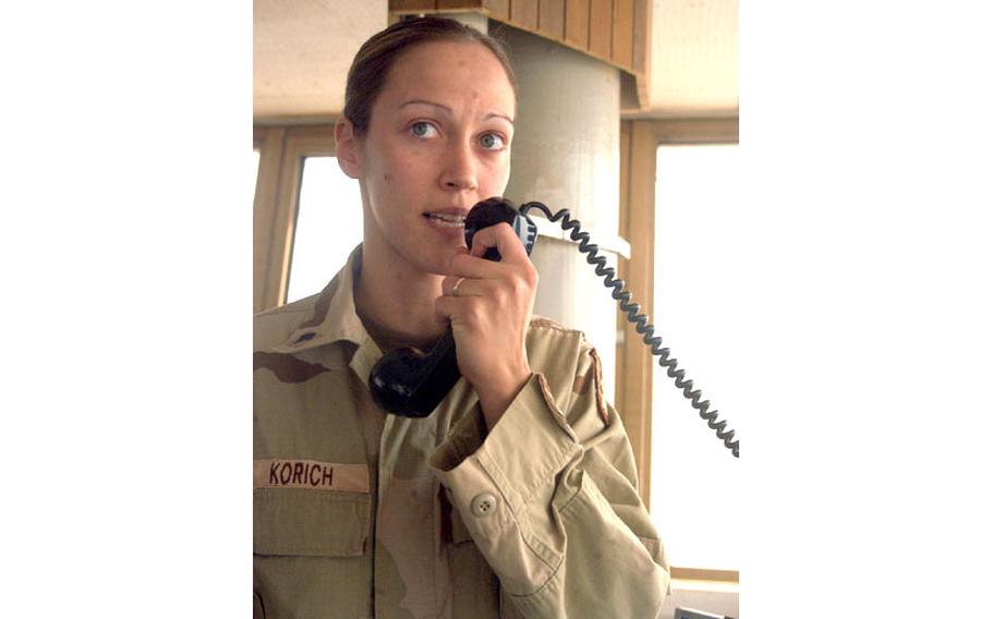 Spc. Erin Korich, an air traffic controller with the 3rd Battalion, 58th Aviation Regiment from Katterbach, Germany, talks to a pilot from the tower at Balad Air Base, Iraq. Army and Air Force controllers work side by side directing a variety of aircraft into the base.