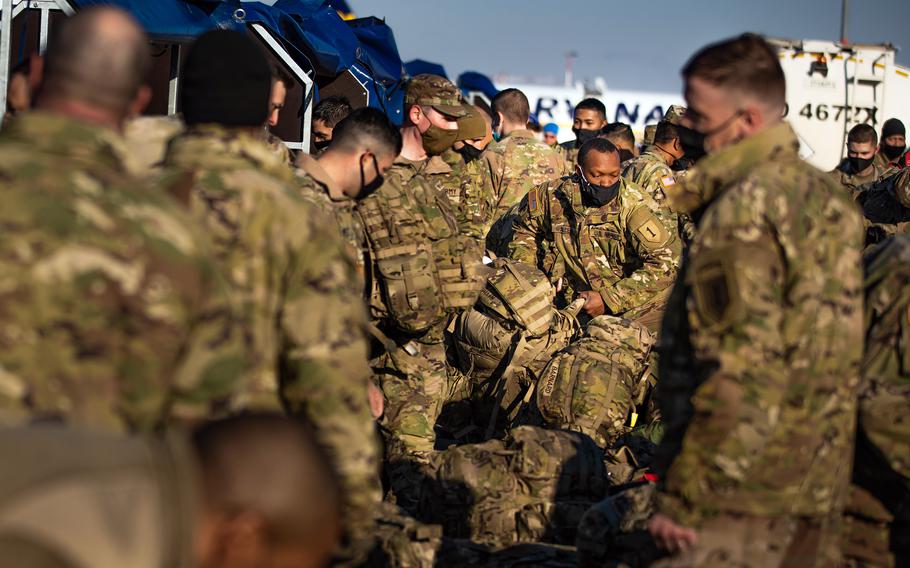 Soldiers assigned to the 1st Infantry Division unload their equipment after arriving in Poland on Feb. 28, 2022. The U.S. now has 100,000 troops in Europe, the most since 2005.