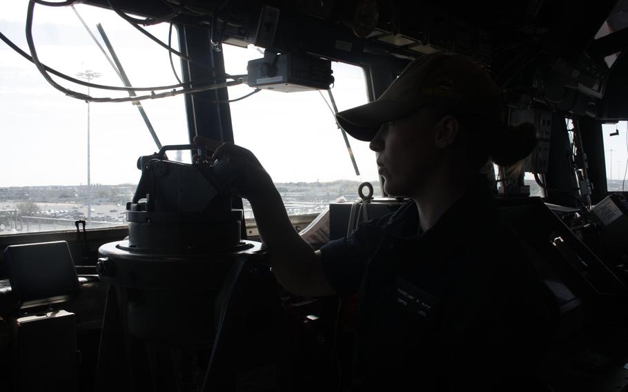 Madeline Rice-Demick, recently qualified as quartermaster of the watch and master helmsman on USS Bulkeley, prepares to take a practice bearing on the bridge.