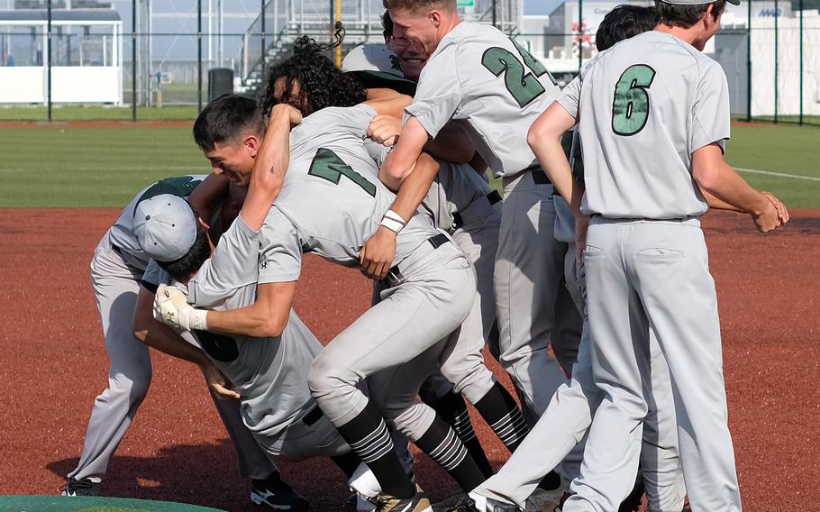 Kubasaki Dragons baseball players form a dogpile on the mound following their 9-3 victory Saturday in the All-DODEA-Japan tournament final over Kadena.