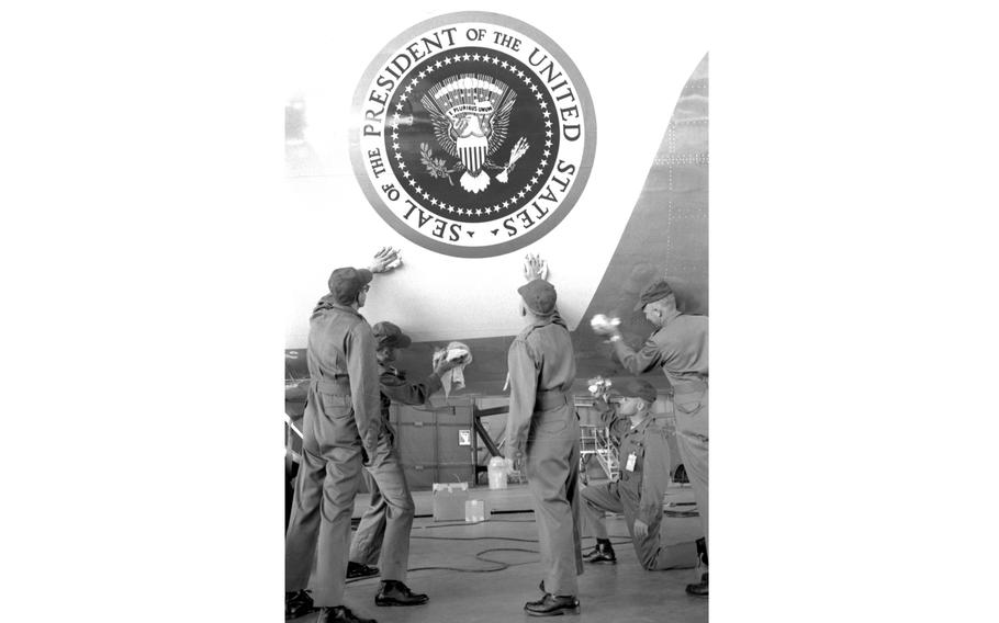 A maintenance crew polishes a presidential aircraft