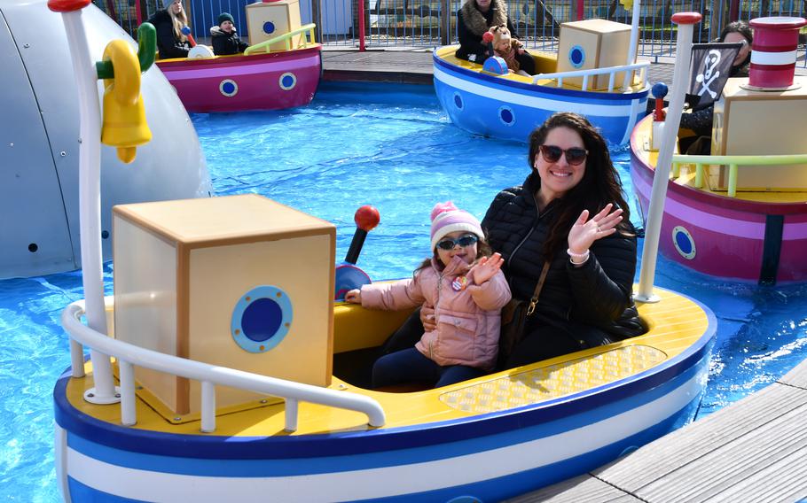 Kelly Alvarez and daughter Penelope ride Grandpa Pigs Boat Trip at Peppa Pig World in Romsey, England, April 2, 2022. All the rides at the theme park allow the option for parents to ride with their kids. 