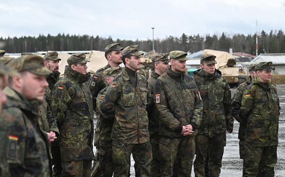 Candidates from the German Army NCO School listen to a discussion about U.S. military equipment during an exchange with soldiers from 1st Battalion, 37th Armored Regiment, in Grafenwoehr, Germany, on Feb. 22, 2024. 
