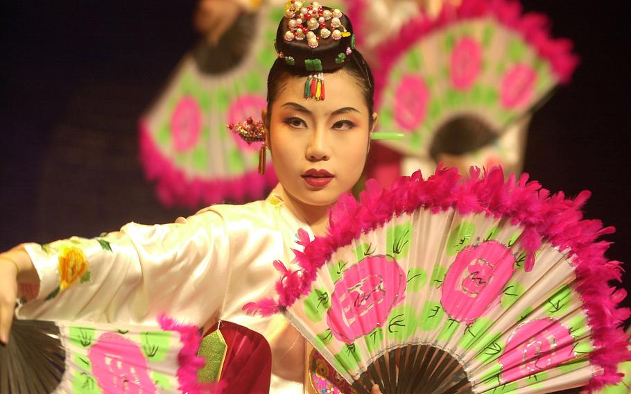 A Korean woman performs a traditional dance