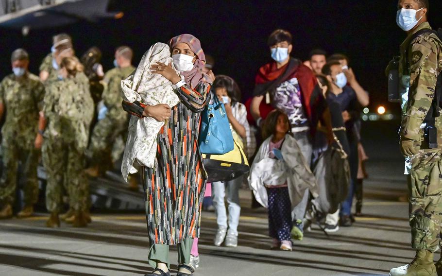 Afghan evacuees disembark a U.S. Air Force C-17 Globemaster III at Naval Air Station Sigonella, Sicily, Aug. 22, 2021. 