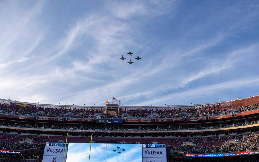 Four Navy jet fighters in formation.