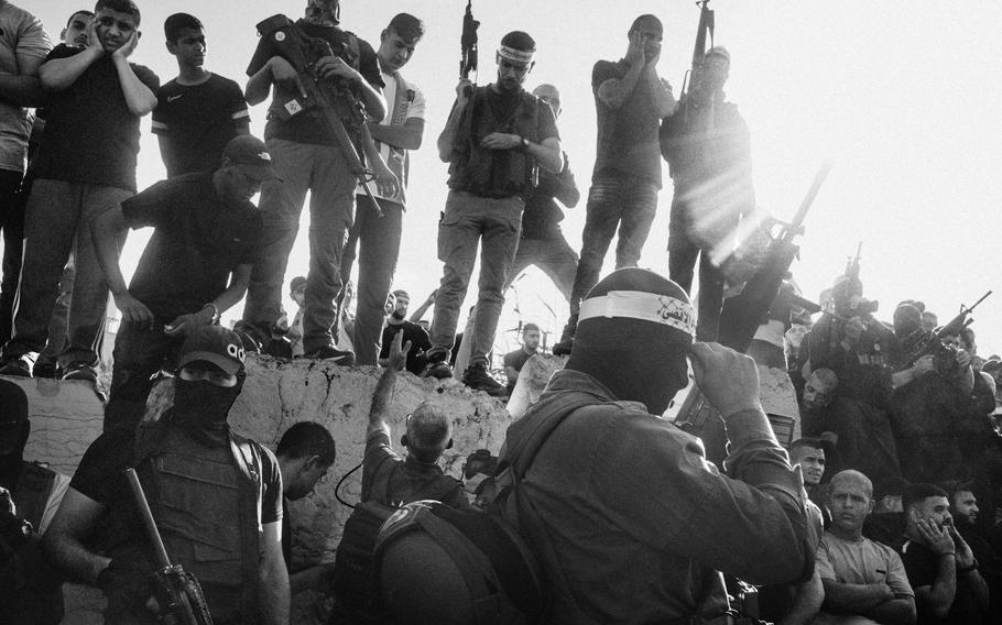 Palestinian militiamen gather during the Oct. 20, 2023, funeral for 13 people killed in an Israeli raid in Nur Shams refugee camp in the West Bank. 