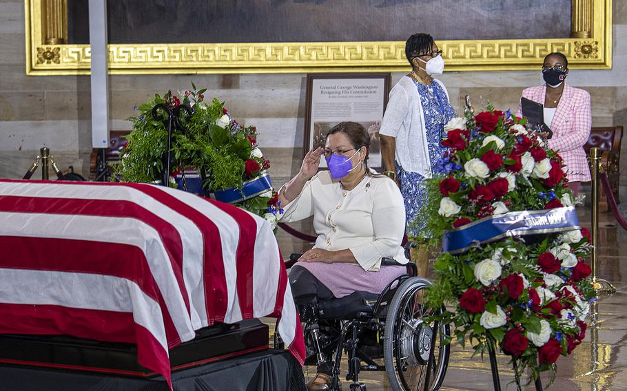 Sen. Tammy Duckworth, D-Ill., a double amputee Army veteran, salutes as she pays her respects before the casket of World War II Medal of Honor recipient Hershel Woodrow "Woody" Williams, who was lying in honor at the U.S. Capitol in Washington, on July 14, 2022.