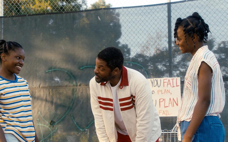 This image released by Warner Bros. Pictures shows Will Smith, center, with Demi Singleton, left, and Saniyya Sidney in a scene from “King Richard.” 