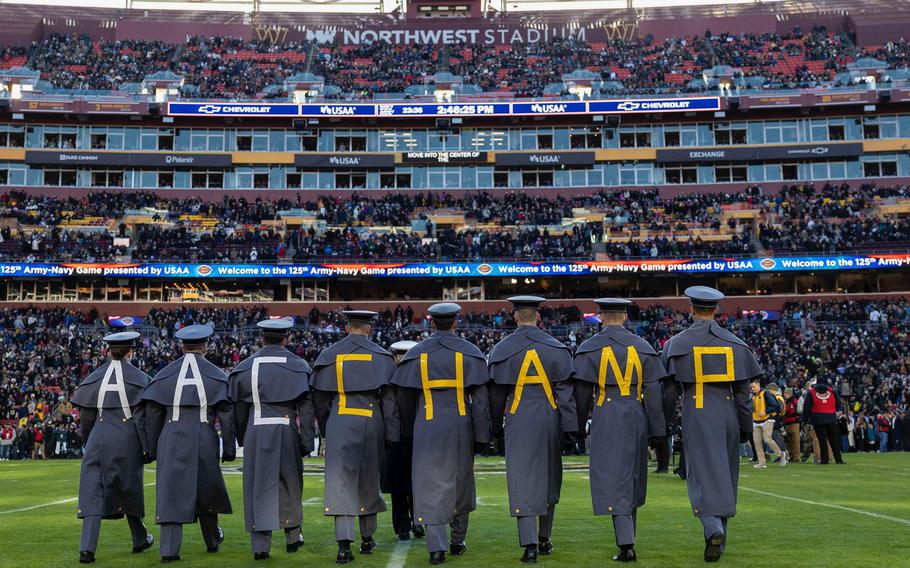 Eigfht West Point cadets pay tribute to Army’s American Athletic Conference Championship. Each cadet has a letter on their backs, spelling AAC CHAMP.