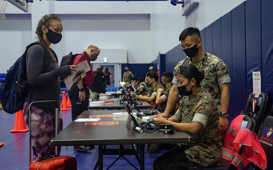 Family members and other nonessential personnel are processed through an evacuation control center during a mandatory three-day exercise at Marine Corps Air Station Iwakuni, Japan, Oct. 13, 2021.