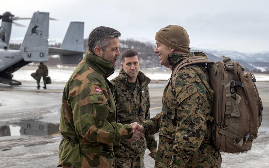 Marine Corps Commandant Gen. David H. Berger, right, greets Norwegian air force Col. Eirik Stueland, commander of the Maritime Helicopter Wing, during Exercise Cold Response 2022 at Bardufoss Air Station, Norway, March 22, 2022. 