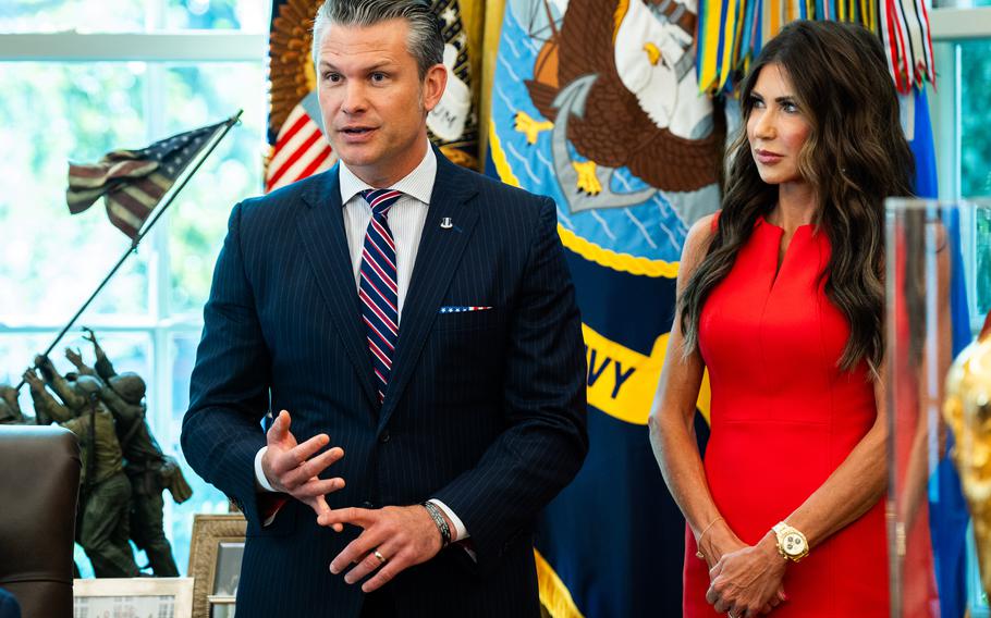 Defense Secretary Pete Hegseth and Homeland Security Secretary Kristi L. Noem stand together in the Oval Office.