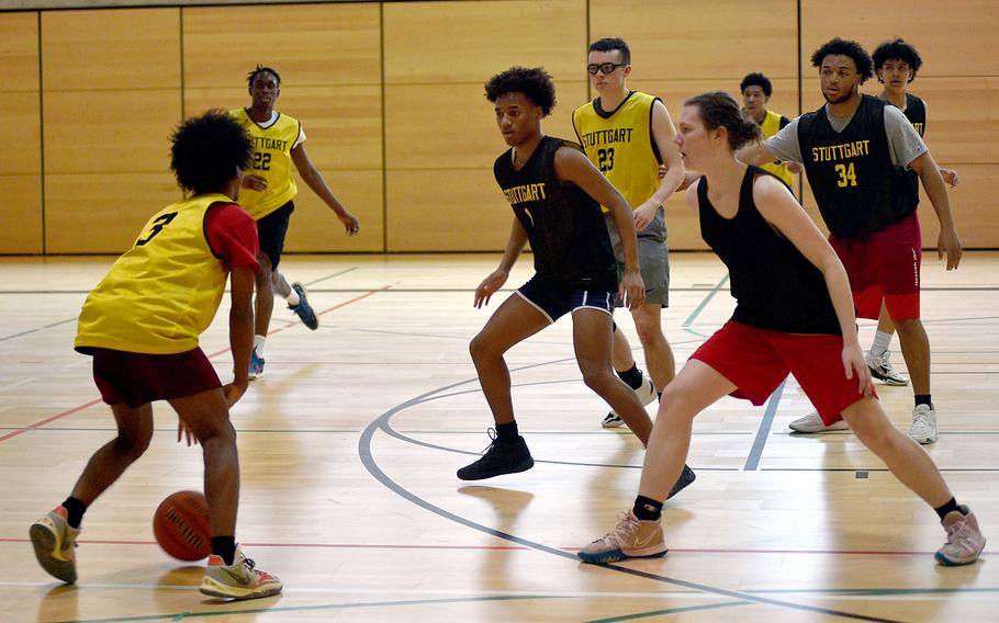 Tyler Jackson, center, and Chris Hess, right, defend Nijah Marshall during a Jan. 31 practice at Stuttgart High School in Stuttgart, Germany. Friends since preschool, the duo reunited in 2017 when the Jackson family returned to Stuttgart, and they have been inseparable since.