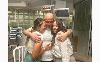 Shlomi Ziv, a rescued hostage embraces his sister, Revital Nasi, and his cousin, Liat Ariel, who struggled for more than 8 months to bring him home, and after the military said that Israeli forces have rescued four hostages alive from the central Gaza Strip, in Ramat Gan, Israel, in this handout image obtained by Reuters on June 8, 2024. 