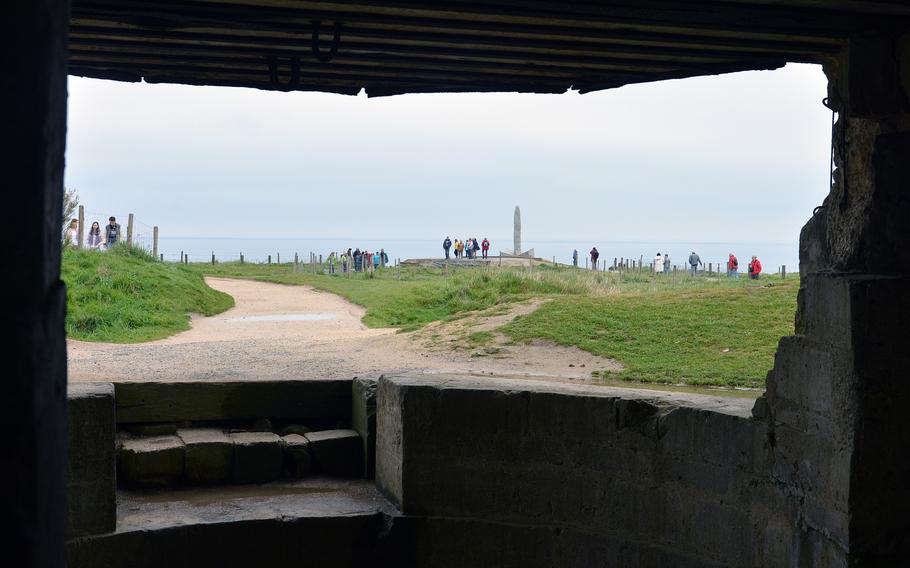 The Ranger Memorial at Pointe du Hoc as seen through the opening of a German gun position.