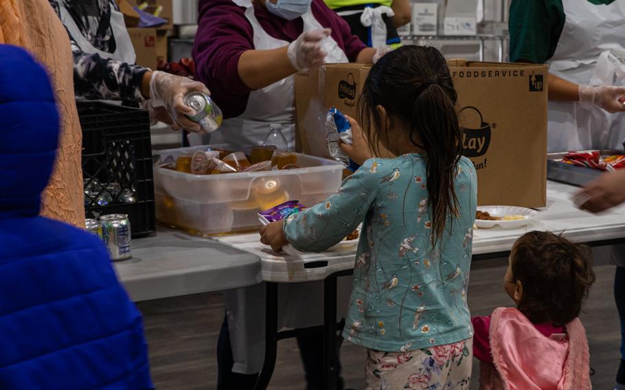 An Afghan child receives lunch in the new dining facility at Aman Omid Village on Holloman Air Force Base, N.M., Oct. 20, 2021. 