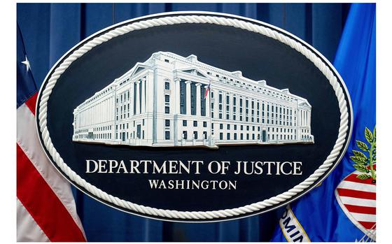 A logo of the Justice Department is seen in Washington, on Nov. 18, 2022. A government official says the U.S. has thwarted a plot to kill Sikh separatist leader Gurpatwant Singh Pannun on American soil. 