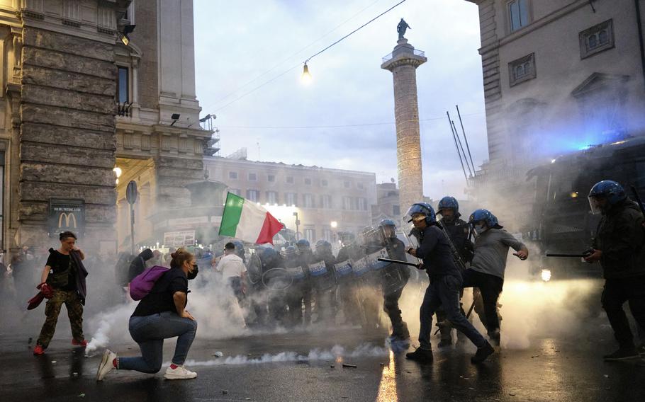 In this Saturday, Oct. 9, 2021 file photo, demonstrators and police clash during a protest, in Rome. An extreme-right political party’s violent exploitation of anger over government anti-pandemic restrictions is forcing Italy to wrestle with its fascist legacy and fueling fears that there could be a replay of last week’s mobs trying to force their way toward Parliament.