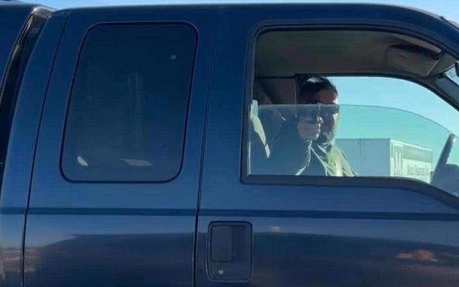 A still image from cell phone video footage captures the moment Air Force Master Sgt. Charles Bass III points a firearm from his vehicle during a Dec. 5, 2023, road rage incident in Surprise, Arizona, a confrontation that led to his arrest, Dec. 19.