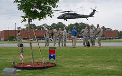 A UH-60 Black Hawk helicopter, from the 3rd Combat Aviation Brigade takes off after dropping off Brig. Gen. James Blackburn (second from right), Command Sgt. Maj. Stanley Varner (right), commander and command sergeant major respectively of, Task Force Marne, 3rd Infantry Division, as well as Gen. Daniel Allyn (third from right), Vice Chief of Staff, U.S. Army, during the VCSA’s visit here at Fort Stewart, April 28. While the VCSA’s visit was brief, he took the time to pay his respects to fellow comrades who had made the ultimate sacrifice, and are memorialized at Warriors Walk, a living memorial to those who were killed in action while serving in the 3rd Infantry Division during the last 12 years of conflict. (U.S. Army photo by Staff Sgt. Richard Wrigley 3rd ID, Public Affairs)