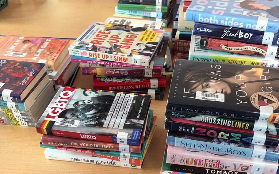 Piles of books on a table.