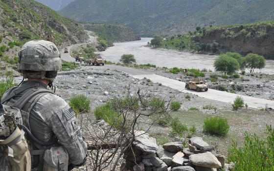 A soldier from A Company, 2nd Battalion, 327th Infantry Regiment looks out over the Kunar River road in Spin Kay on Aug. 2, 2010 a site of frequent attacks by insurgents in the mountains on either side of the river. In the summer of 2010 Combat Outpost (COP) Monti suffered a spade of deadly attacks that would reverberate throughout the outpost and back home. Across 31 days, a staggering nine men at COP Monti were killed in insurgent attacks. Several more were wounded, and still others were pulled from the theater, succumbing to the psychological strain, before death finally released its grip on the embattled base. Read Dianna Cahn's story of the men of COP Monti here. 

META TAGS:  Afghanistan; Operation Enduring Freedom; Company A, 2nd Battalion, 327th Infantry Regiment, 101st Airborne Division; U.S. Army; IED; Combat Outpost Monti; 