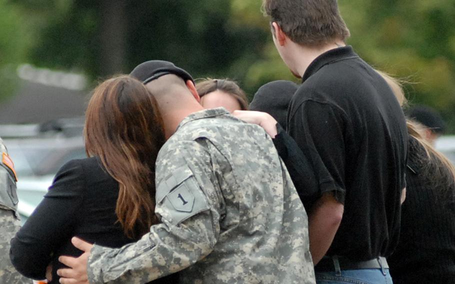 Mourners hug after a 2007 memorial ceremony in Schweinfurt, Germany, for 2nd Brigade Combat Team soldiers killed in Iraq. Some 4,599 U.S. troops died in Iraq in the two decades following the invasion of the country in March 2003, according to Defense Department casualty figures. 