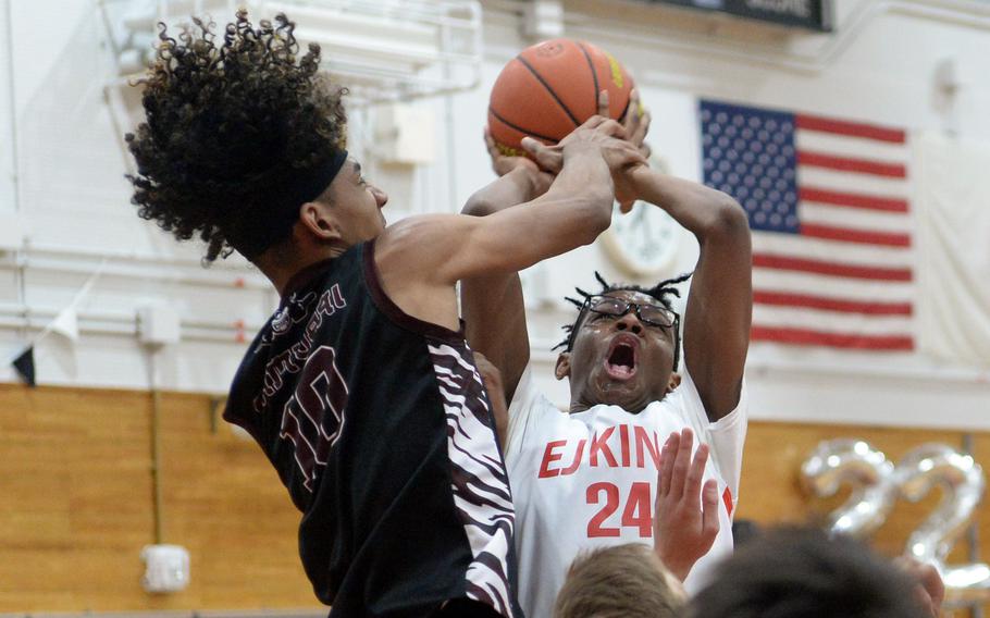 Matthew C. Perry's Shion Fleming blocks a shot attempt by E.J. King's Keith Lombard during Friday's DODEA-Japan boys basketball game. The Cobras won 57-53.