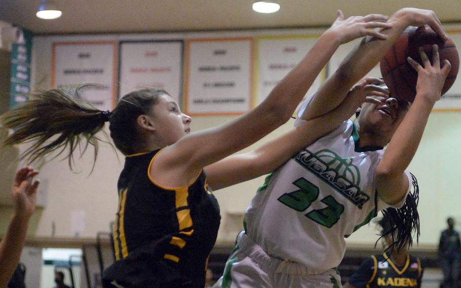 Kubasaki's Alannah Ridgway snares a rebound against Kadena's Presley Pearce during Thursday's season-opening Okinawa basketball game. The Panthers won 48-2.