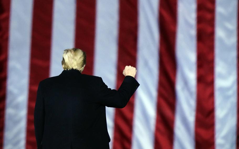 President Donald Trump gestures at a campaign rally in support of U.S. Senate candidates Sen. Kelly Loeffler, R-Ga., and David Perdue in Dalton, Ga., Monday, Jan. 4, 2021. (AP Photo/Brynn Anderson)