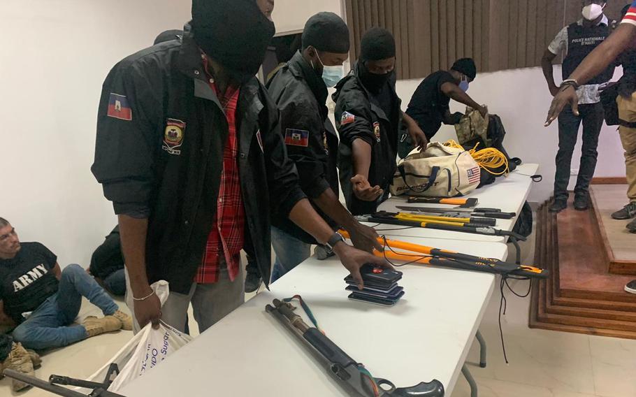 Haitian police display some of the weapons they say they took from men who were involved in the July 2021 assassination of President Jovenel Moïse.