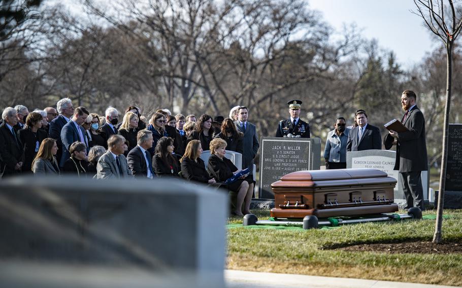 A small crowd gathers at the Arlington National Cemetery grave site in Arlington, Va., where former Sen. Bob Dole was buried on Feb. 2, 2022.