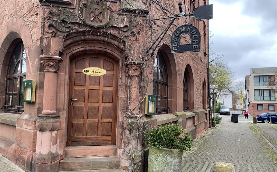 The flammkuche sign outside Nora Restaurant in Kaiserslautern offers a hint of the oven-baked delights that await inside, April 1, 2022. The pizza-like Alsatian dishes are a specialty at the eatery, where both traditional flavors and more American-style versions are on offer.