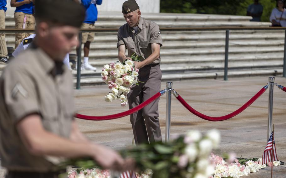 Soldiers pick up and move the flowers.