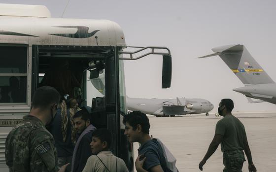 Men in line to board a bus.