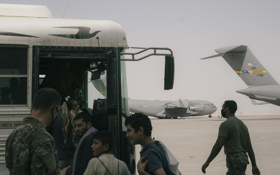 Men in line to board a bus.