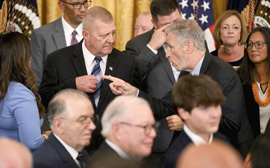 Comedian and activist Jon Stewart speaks to Jerry Ensminger, a Camp LeJeune survivor, during a signing ceremony for the PACT Act of 2022, in the East Room of the White House in Washington, D.C., on Aug. 10, 2022. 