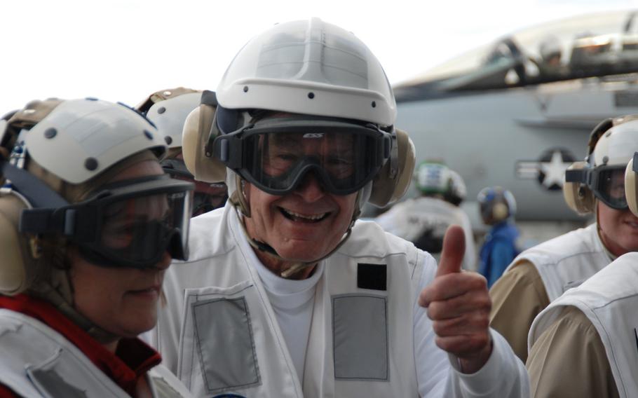 Former President George H.W. Bush, standing alongside his daughter Doro Bush Koch, gives a “thumbs-up” after watching aircraft catapult off and land on the flight deck of USS George H.W. Bush on May 26, 2009.