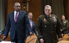 Secretary of Defense Lloyd Austin, left, and General Mark Milley, chairman of the Joint Chiefs of Staff, arrive to testify before the Senate Appropriations Committee on the Department of Defense budget request, on Capitol Hill in Washington, Tuesday, May 3, 2022. (AP Photo/J. Scott Applewhite)