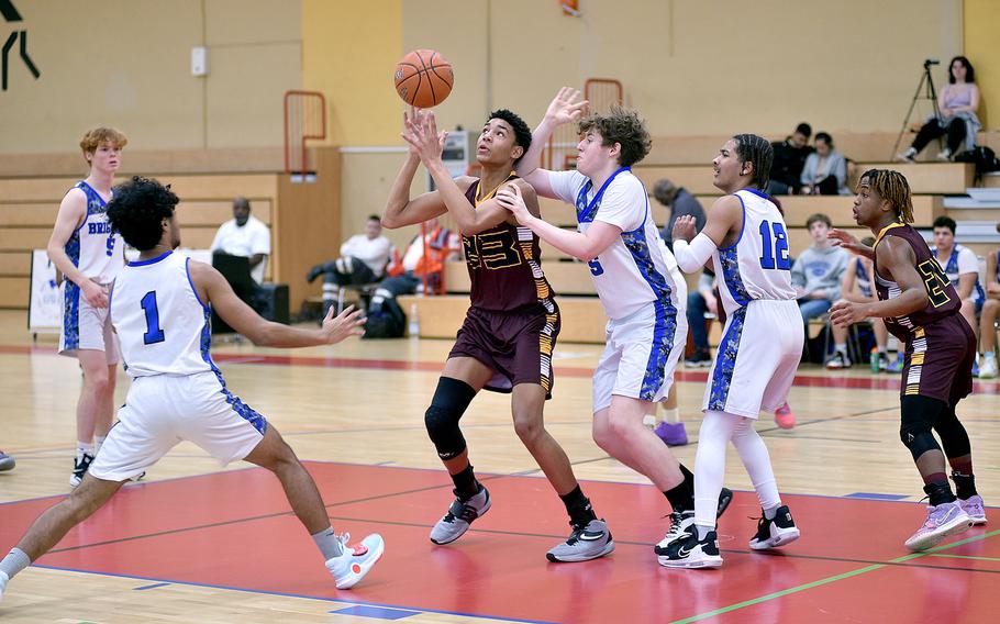 Baumholder's Damian Jung tries to control the basketball as Brussels' Nandor Arnold, center, defends during a game Saturday afternoon at the Hall of Champions Fitness Center in Baumholder, Germany. The Brigands' Jabriel Wells, left, and Damick Rogers, second from right, step in to help while the Buccaneers' Jonathan Kimuli, right, watches.