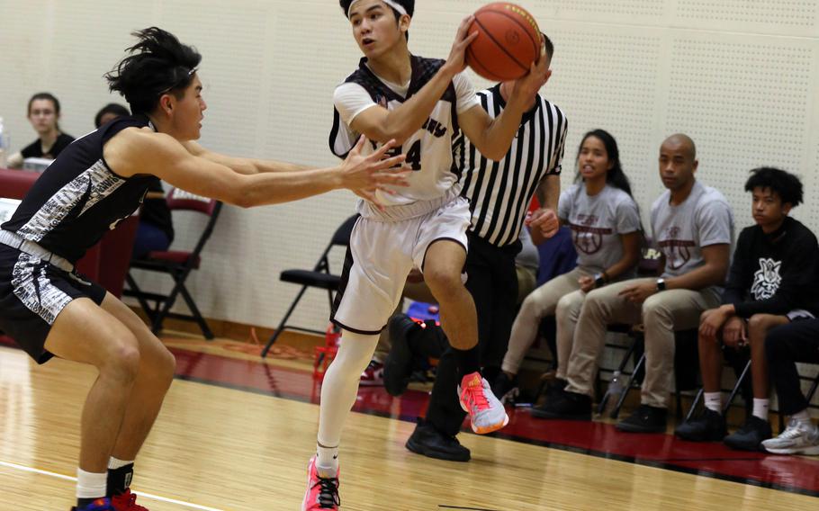 Matthew C. Perry's Kameron Ramos looks for room against Zama American's Keahnu Araki during Friday's DODEA-Japan boys basketball game. The Samurai won 58-44.