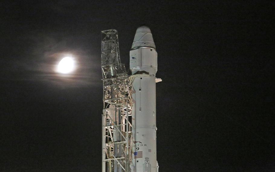 A gibbous moon shines early on June 28, 2015, as a SpaceX Falcon 9 rocket is set to launch at the Cape Canaveral Air Force Station, Florida.