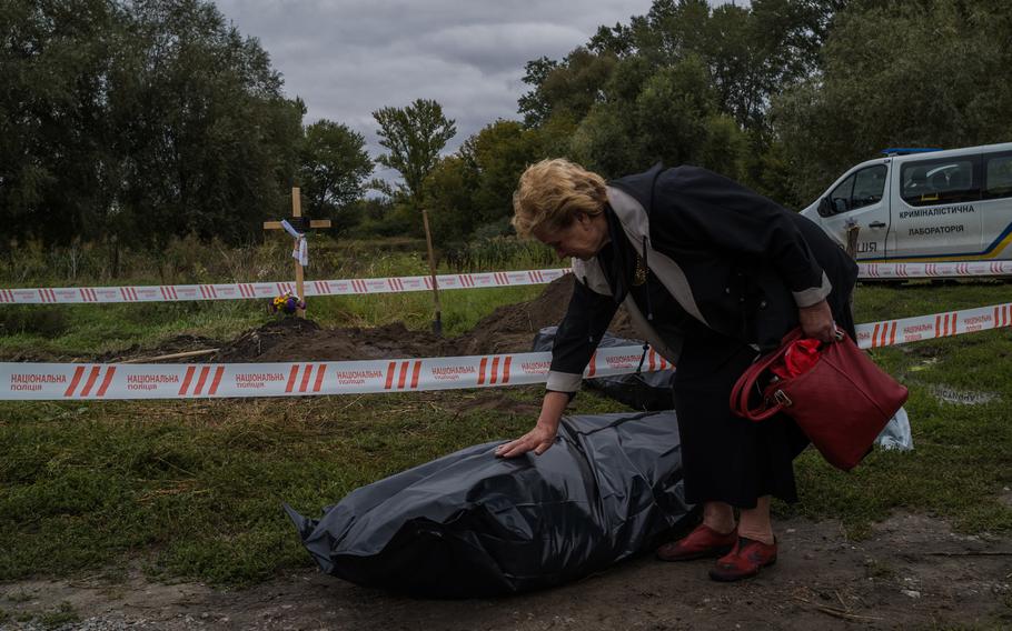 Valentyna Shepel, in the freshly liberated Balakliya, Ukraine, mourns over the exhumed body of her son Pyotr Shepel, who was killed at a checkpoint last week. Throughout the Kharkiv region, civilians who survived the Russian assault are now adjusting to their new reality.