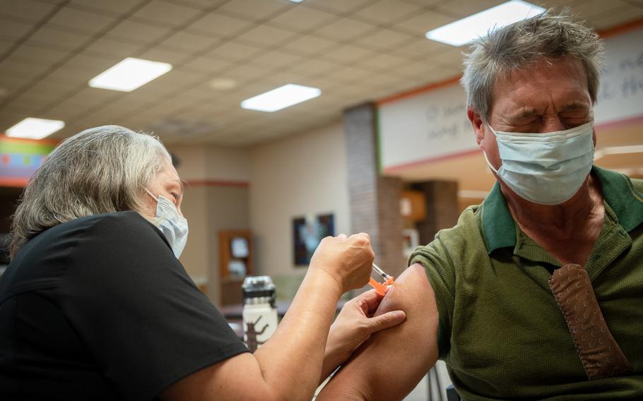 Nurse Susan Hinck gives Richard Thornton a coronavirus vaccine July 10 in Springfield, Mo., where hospital wards have filled with COVID-19 patients.