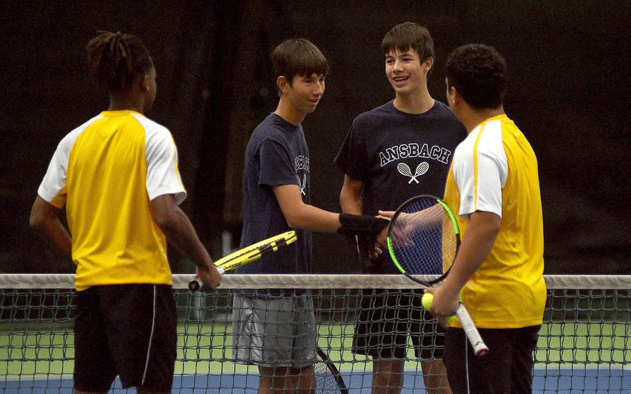 Ansbach's Bobby and Jack Lovallo, center left and center right, shake hands with Bahrain's Carson Owens and Mathew Mendoza after their pool-play match during the DODEA European tennis championships on Oct. 19, 2023, at T2 Sports Health Club in Wiesbaden, Germany.